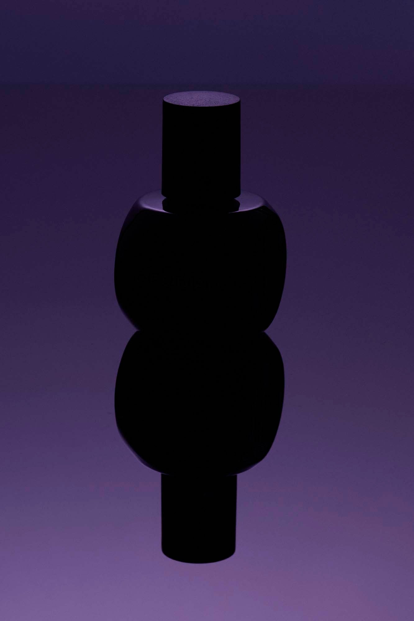 Osmé Obsidian luxury fragrance displayed in a minimal, modern lifestyle setting